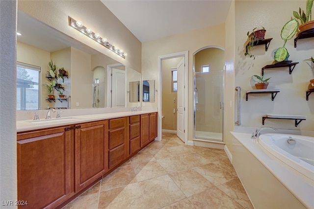 bathroom with shower with separate bathtub, tile patterned floors, and dual vanity