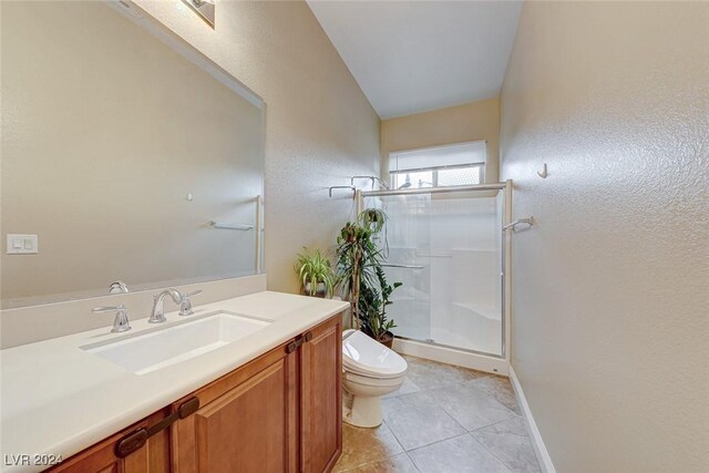 bathroom featuring tile patterned floors, vanity, an enclosed shower, and toilet