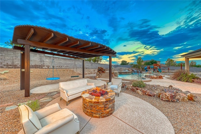 view of patio with an outdoor living space with a fire pit