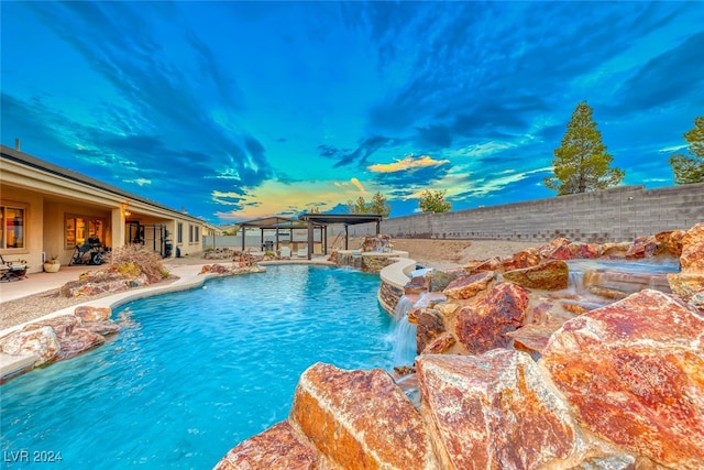 view of swimming pool featuring a patio, pool water feature, and a gazebo