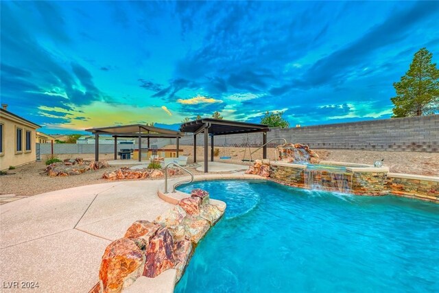 view of swimming pool with pool water feature, a gazebo, and a patio area