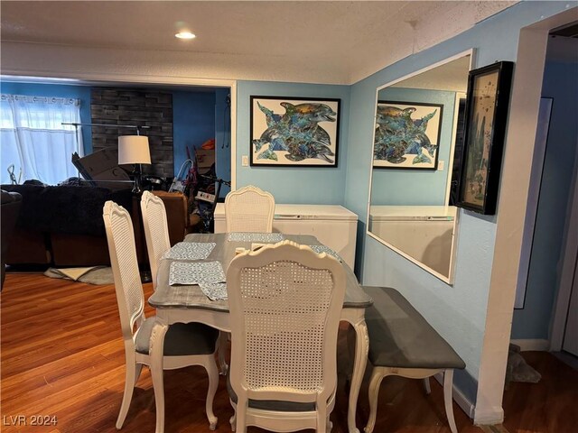 dining area with a textured ceiling and wood-type flooring