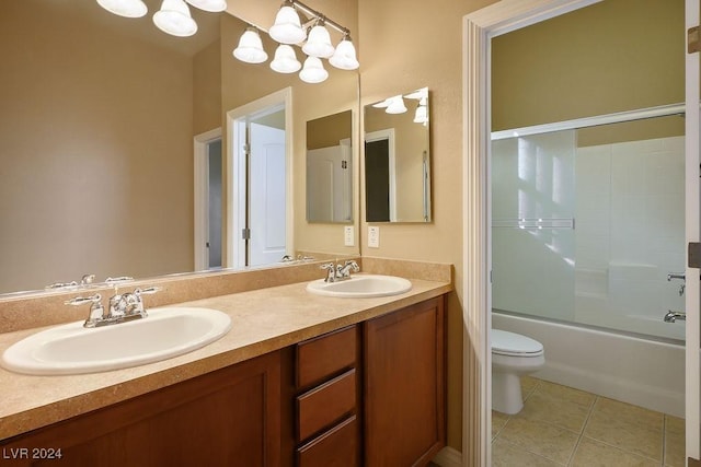 full bathroom with shower / bath combination with glass door, vanity, toilet, tile patterned floors, and an inviting chandelier