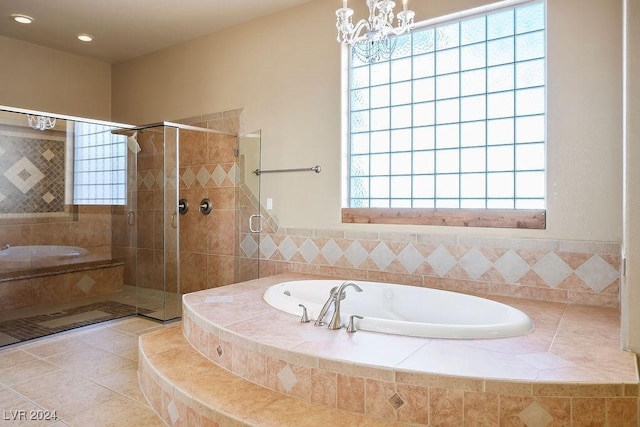 bathroom featuring shower with separate bathtub, tile patterned floors, and an inviting chandelier