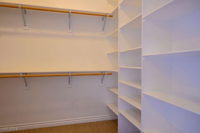 spacious closet featuring tile patterned flooring