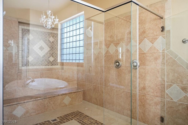 bathroom with an inviting chandelier and independent shower and bath