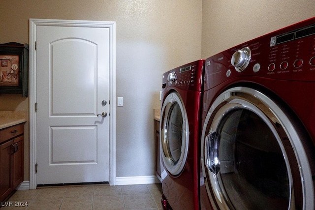 clothes washing area featuring light tile patterned floors and independent washer and dryer