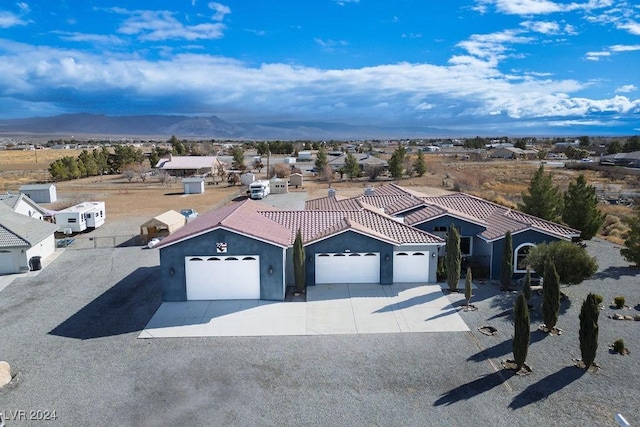 view of front of house with a mountain view and a garage