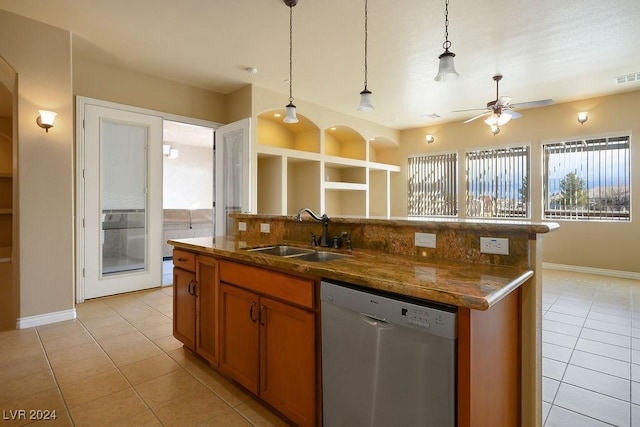 kitchen with sink, a center island with sink, light tile patterned floors, stainless steel dishwasher, and pendant lighting