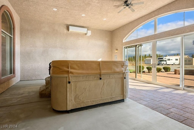 living room with a wall mounted AC and ceiling fan