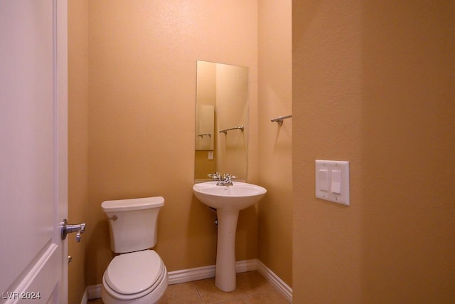 bathroom with tile patterned floors, toilet, and sink