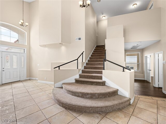 entrance foyer featuring a chandelier, hardwood / wood-style floors, and a high ceiling