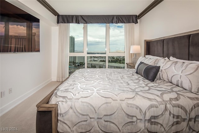 bedroom with carpet flooring and crown molding