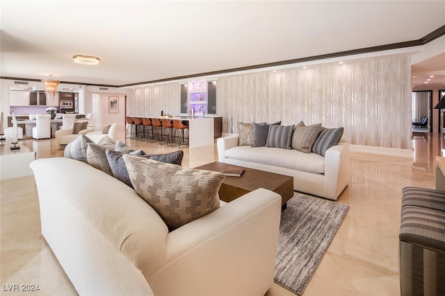 living room with light tile patterned flooring, sink, and crown molding