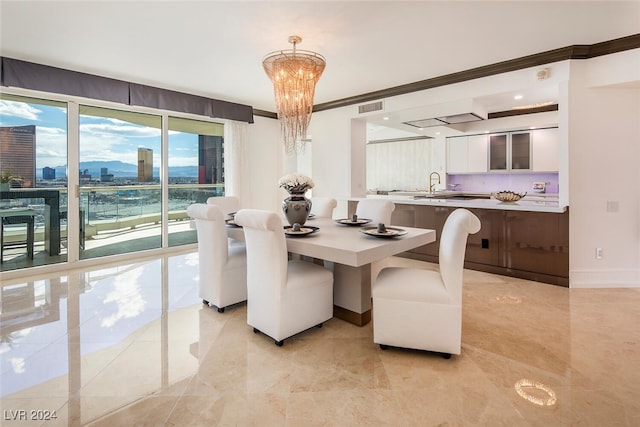 tiled dining space with a notable chandelier and ornamental molding