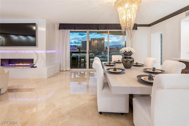 dining space with a notable chandelier, tile patterned floors, and ornamental molding