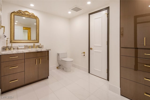 bathroom with tile patterned floors, vanity, and toilet