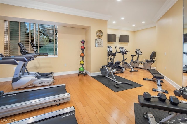 workout area with ornamental molding and wood-type flooring