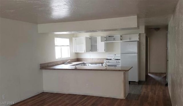 kitchen featuring white cabinetry, dark hardwood / wood-style flooring, white appliances, and kitchen peninsula