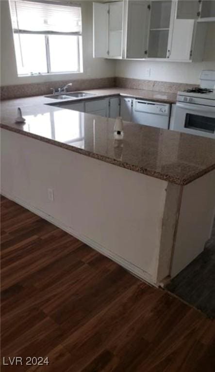 kitchen featuring dark wood-type flooring, sink, white cabinetry, light stone counters, and white appliances