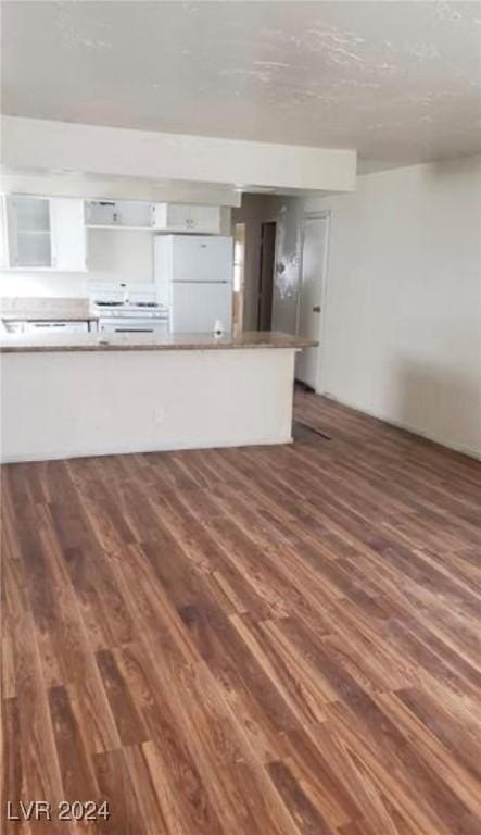 unfurnished living room featuring dark hardwood / wood-style flooring