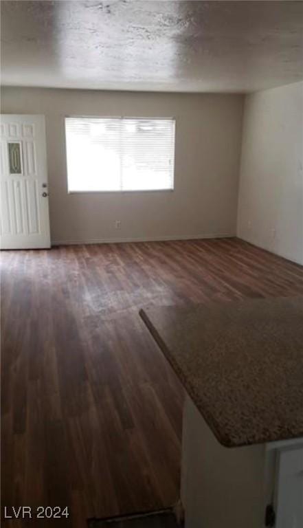 spare room featuring dark hardwood / wood-style floors