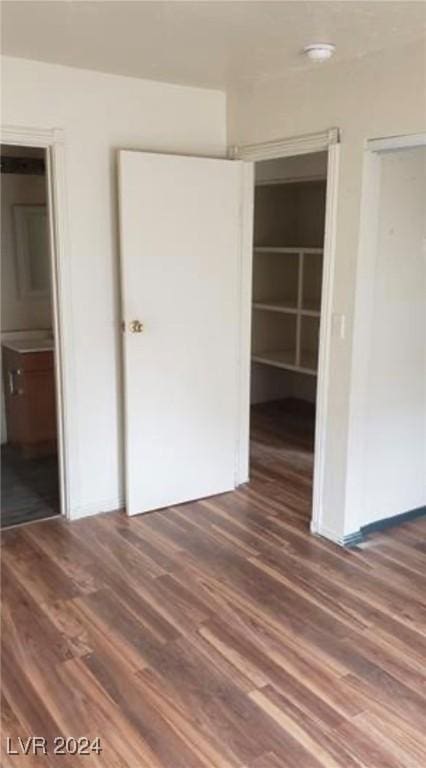 unfurnished bedroom featuring dark hardwood / wood-style flooring