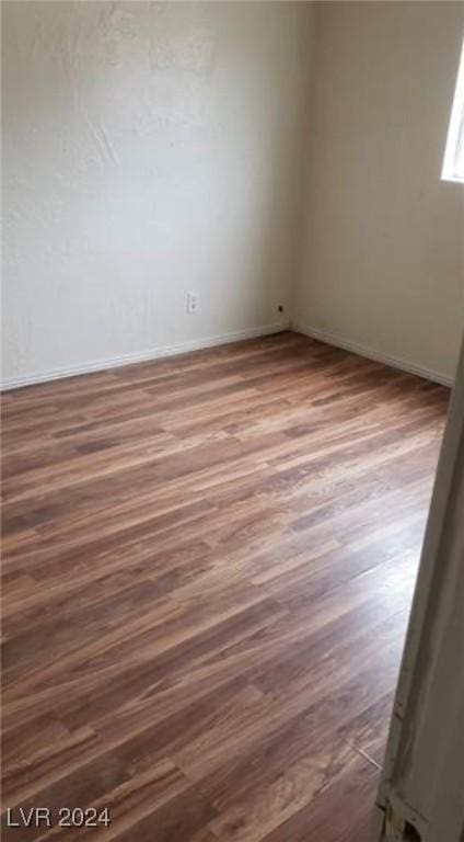 spare room featuring dark wood-type flooring