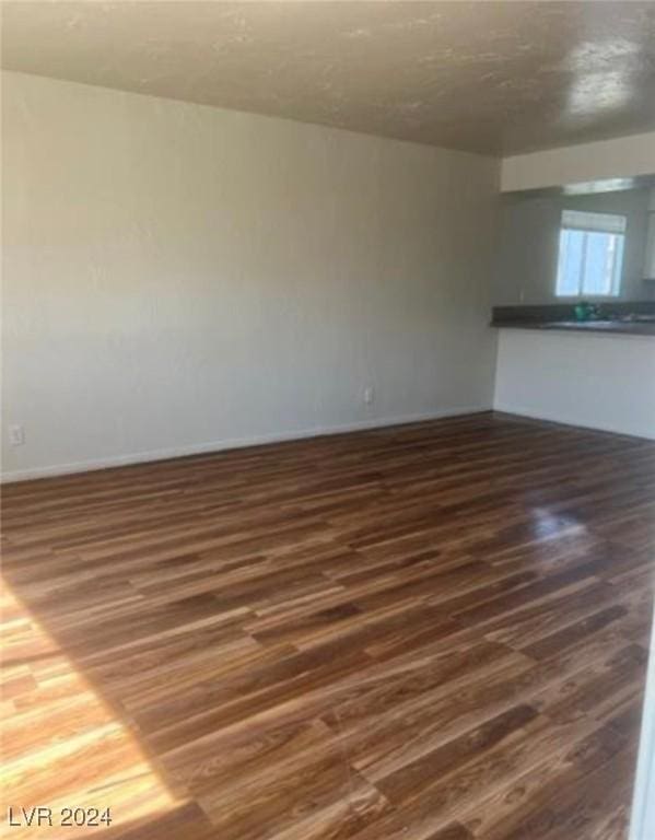 empty room with dark hardwood / wood-style floors