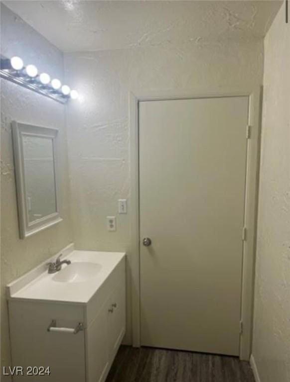 bathroom featuring wood-type flooring and vanity