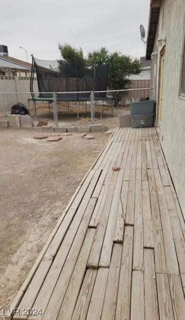 wooden terrace featuring a trampoline