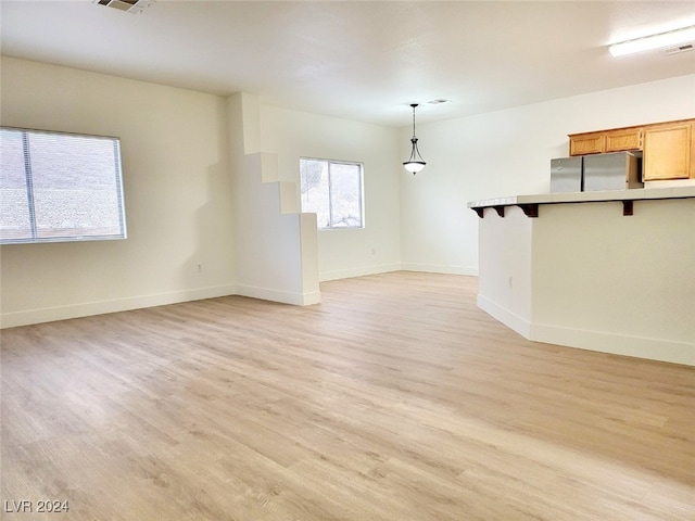 unfurnished living room featuring light hardwood / wood-style flooring