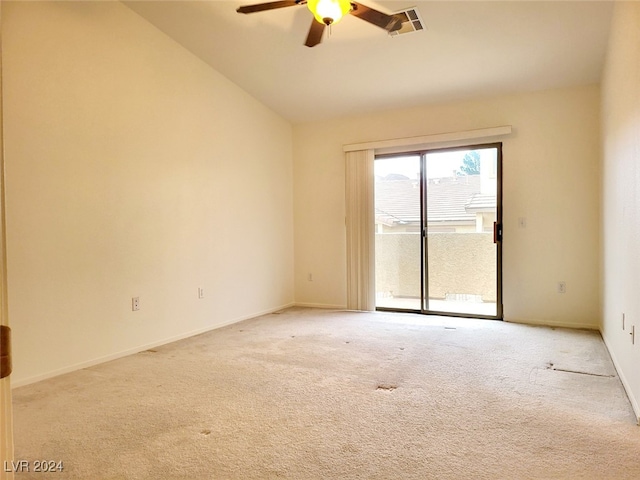 carpeted spare room with ceiling fan and lofted ceiling