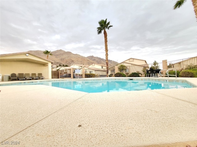 view of pool featuring a patio area and a mountain view