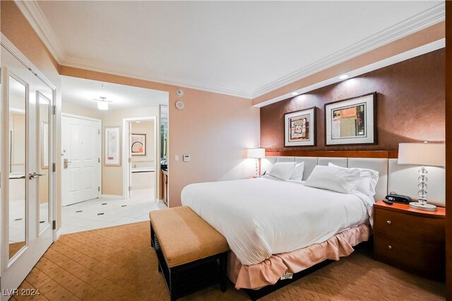 tiled bedroom with ensuite bath and ornamental molding