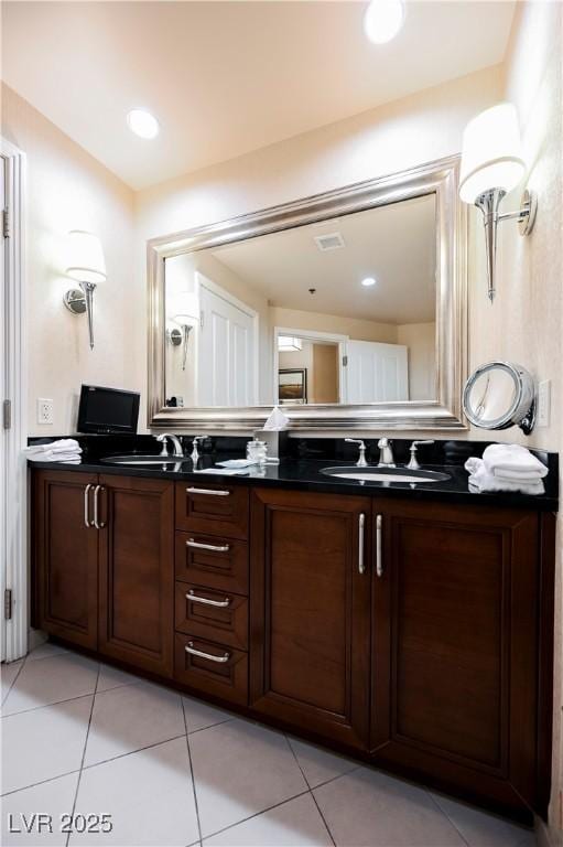 full bathroom featuring tile patterned floors, visible vents, a sink, and double vanity