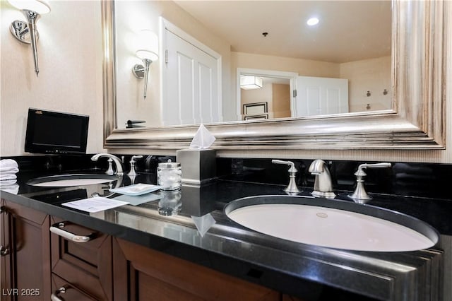 bathroom featuring double vanity and a sink