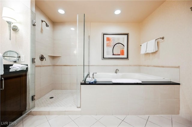 full bath with a garden tub, a shower stall, vanity, and tile patterned floors