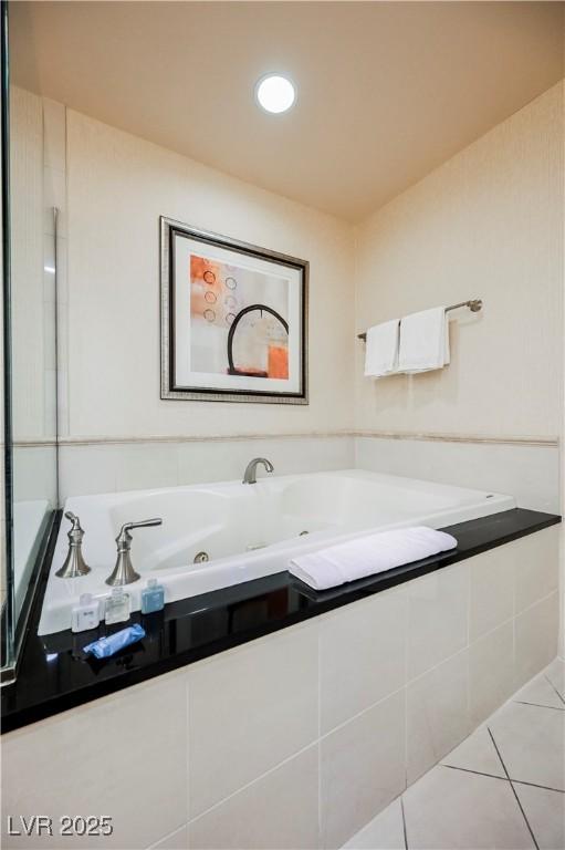 full bathroom with a whirlpool tub and tile patterned floors