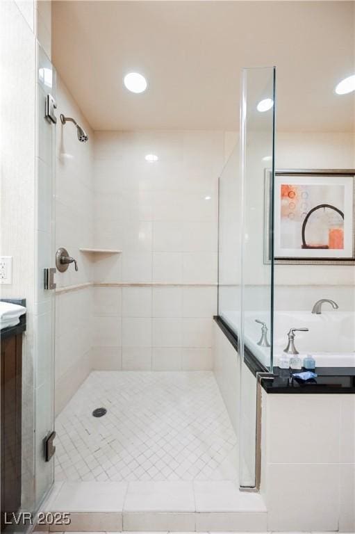 full bathroom with a stall shower, vanity, and recessed lighting