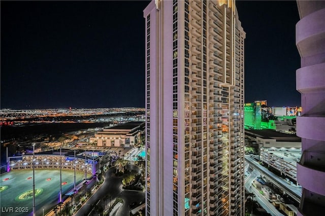 property at night featuring a view of city lights