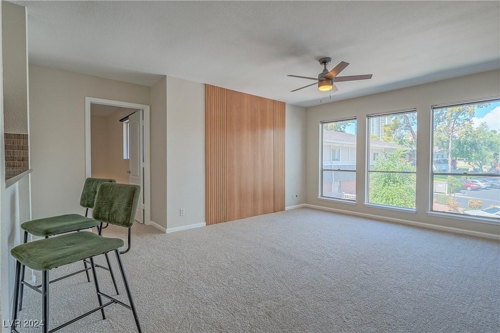 empty room with light carpet and ceiling fan