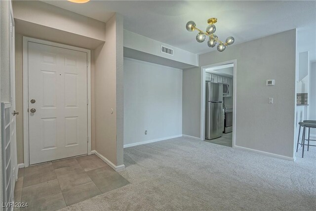 interior space featuring a notable chandelier and light colored carpet