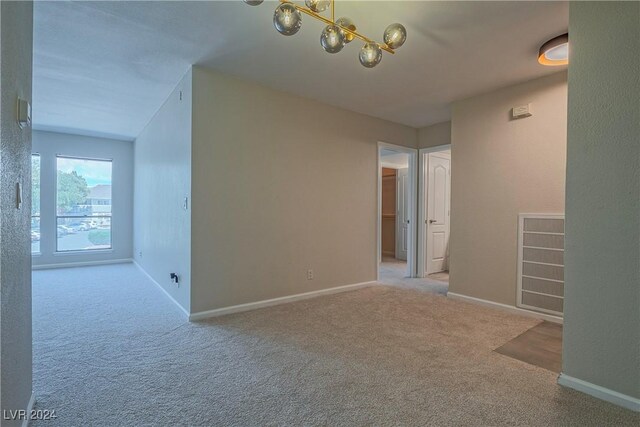 spare room featuring light colored carpet