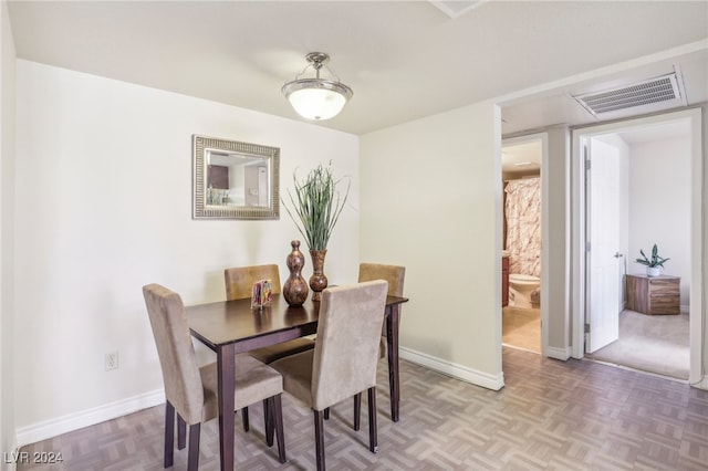 dining space featuring parquet floors