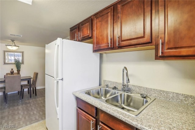 5185 Indian River Dr Unit 225, Las Vegas, NV 89103 - kitchen featuring freestanding refrigerator and light countertops