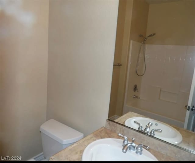 full bathroom with tub / shower combination, toilet, and sink