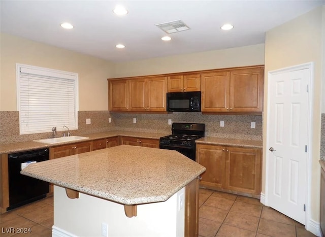 kitchen with backsplash, a kitchen island, sink, and black appliances