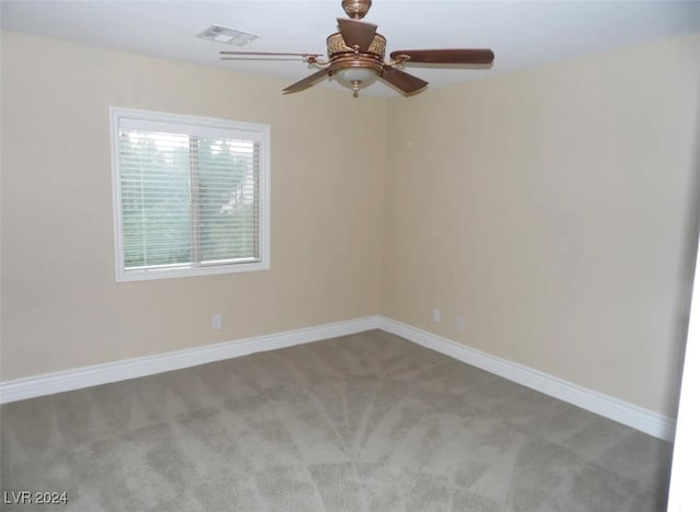 unfurnished room with ceiling fan and carpet