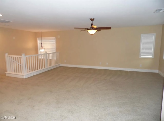 carpeted empty room featuring ceiling fan